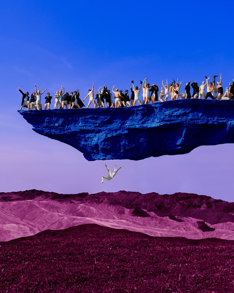 Large group of people on a floating blue rock formation, with one person falling down towards purple grass and hills under a blue sky.