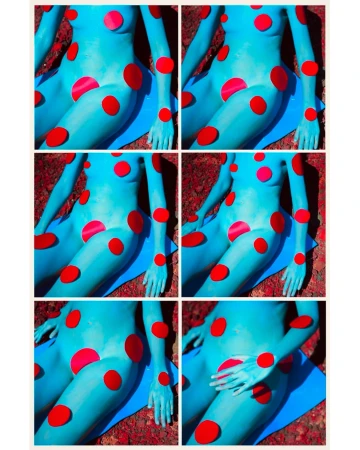 Abstract image of a blue body painted in the style of a cartoon, with red polka dots. A blue mat lies beneath the figure.