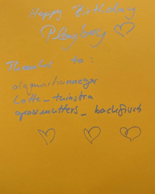 Handwritten message on bright orange background including words like 'Happy Birthday' and 'Playboy' along with other text.