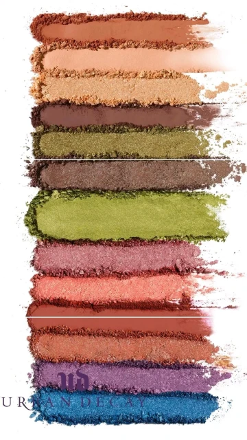 Close-up of eyeshadow palette with various shades of brown, green, coral, purple, and blue pigments in rectangular swatches.