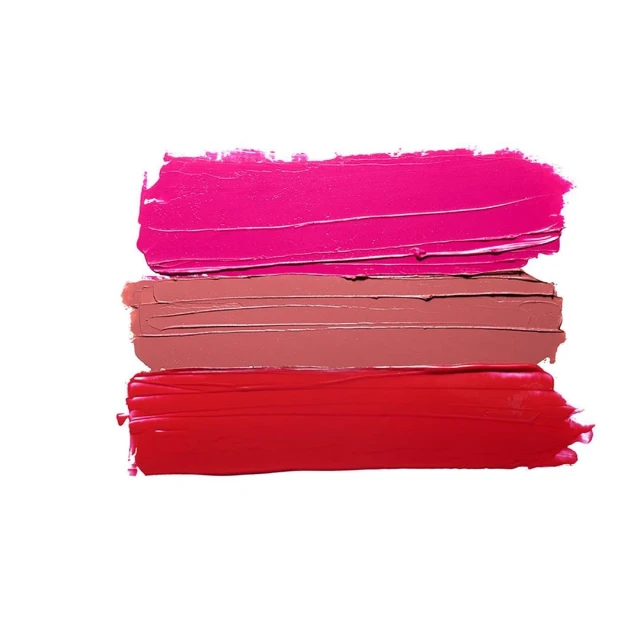 Three textured swipes of lipstick in red, pink, and nude tones against a bright white background in a makeup advertisement.