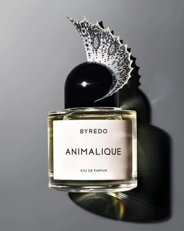 Studio shot of Byredo Animalique Eau de Parfum bottle with decorative butterfly element on grey background, perfume, cosmetics, beauty.