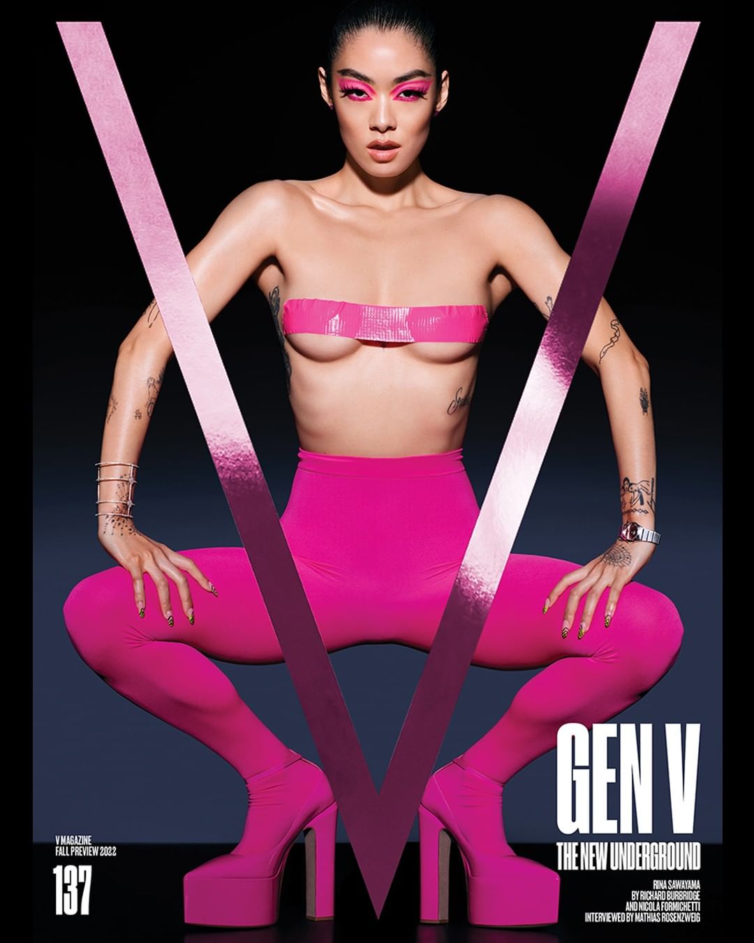 V Magazine cover featuring a woman in pink high heels, leggings, and tape, with pink eye makeup, posing in front of the letter V.