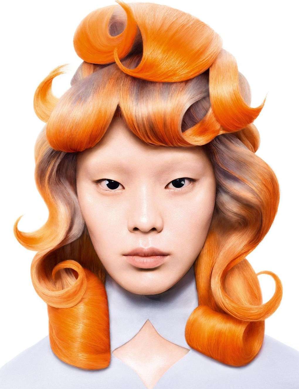Artistic close-up of a model with pale skin and elaborate orange curled hairstyle, set against a clean white background in a studio shot.
