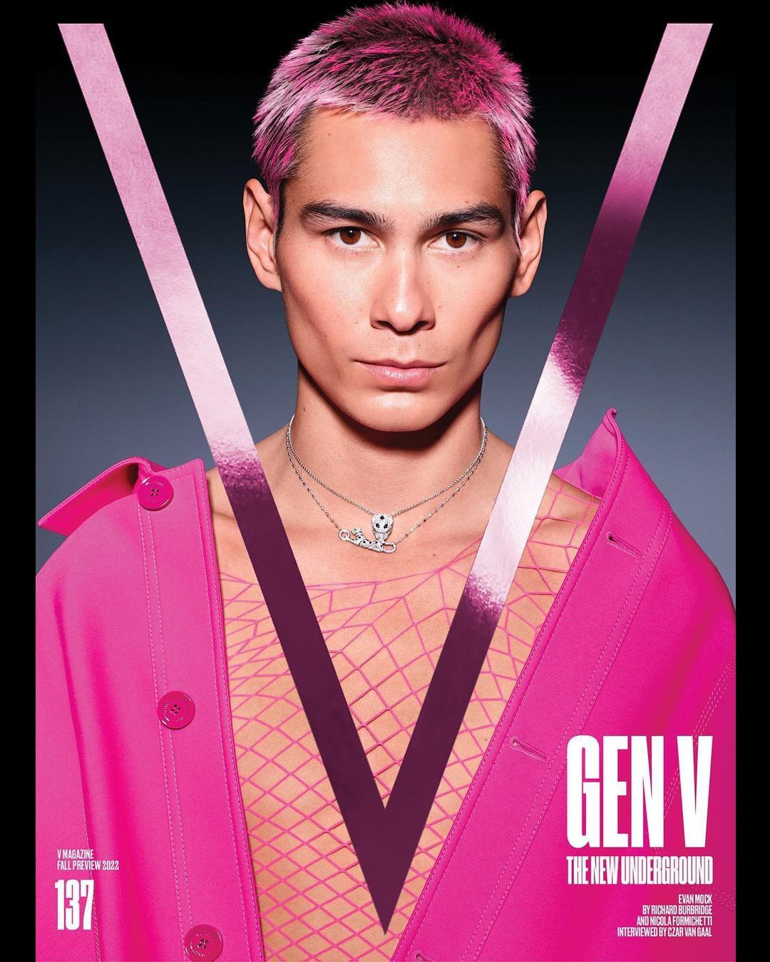 Magazine cover featuring a fair-skinned person with pink hair, wearing a pink jacket, against a dark background with a large 'V' graphic.
