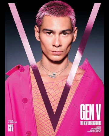 Magazine cover featuring a fair-skinned person with pink hair, wearing a pink jacket, against a dark background with a large 'V' graphic.