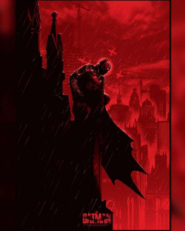 Dramatic illustration of Batman perched on a gothic building in the rain, gazing over a dark city skyline bathed in an ominous red glow.