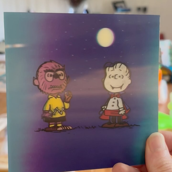 Whimsical illustration featuring two 'Peanuts' characters in Halloween costumes against a starry, gradient blue and purple night sky backdrop with a full moon.