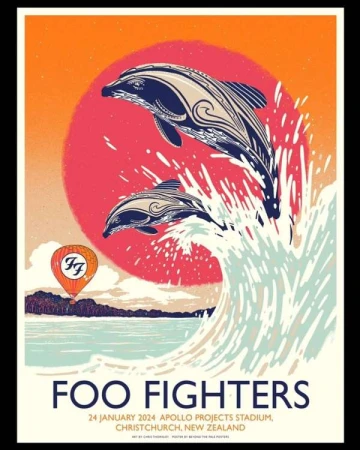 Poster art featuring two dolphins leaping from ocean waves, against a sun and coastal background with a hot air balloon.