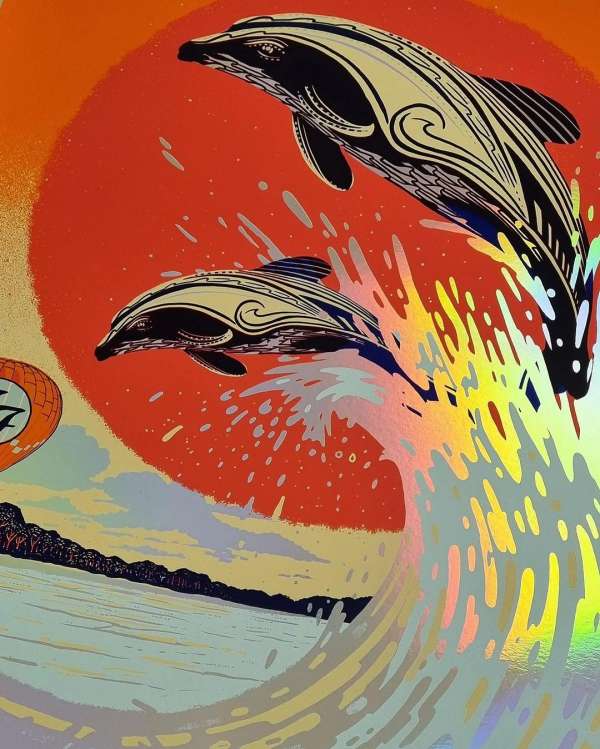 Artwork of two stylized dolphins leaping out of a crashing wave against a sunset background with land and trees in the distance.