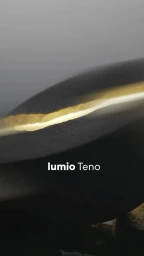 Close-up product shot of Lumio Teno light emitting a warm golden glow from inside a textured dark bowl shape.
