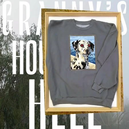 Gray sweatshirt featuring a Dalmatian dog graphic in a wooden frame, set against an outdoor background with text overlay.
