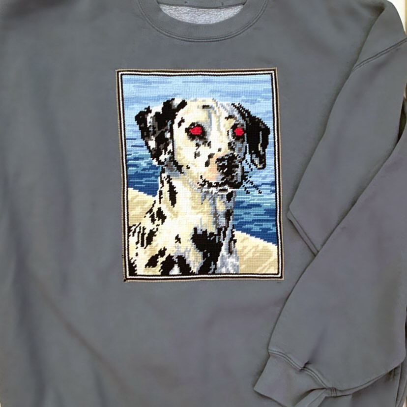 Gray sweatshirt featuring a pixelated-style graphic patch of a Dalmatian dog's face against a light blue and tan background.