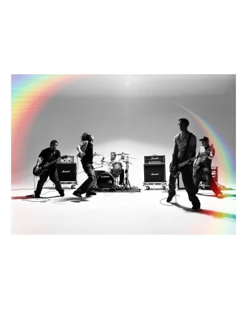 A band of five members performs on a white stage with music equipment. The members play instruments and stand under bright, even lighting.