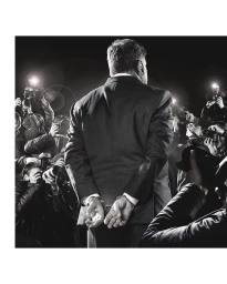 Man in handcuffs photographed from behind surrounded by paparazzi with cameras and flashbulbs