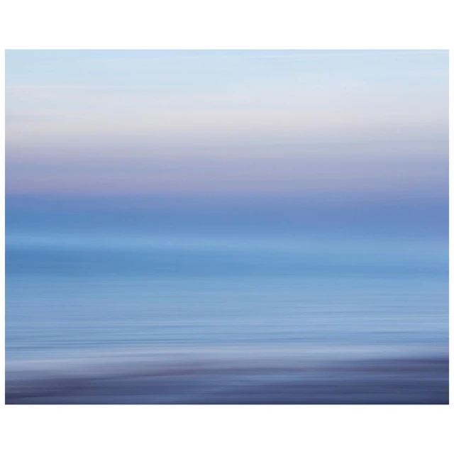 Abstract ocean and sky blend in a long exposure shot, creating a serene, dreamy seascape with smooth water and soft pastel colors.