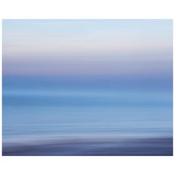 Abstract seascape photography with horizontal bands of soft blue and muted lavender tones blending into a misty horizon line.