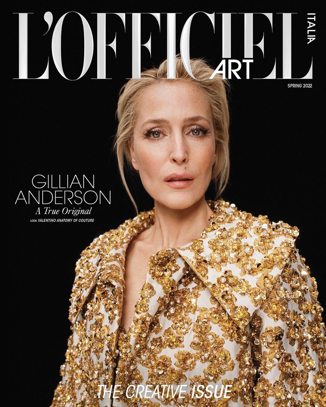 Gillian Anderson on the cover of L'Officiel Italia Art Spring 2022 issue. She wears a gold-sequined jacket against a dark backdrop.