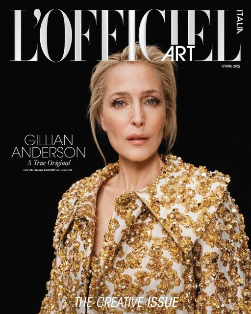 Gillian Anderson on the cover of L'Officiel Italia Art Spring 2022 issue. She wears a gold-sequined jacket against a dark backdrop.