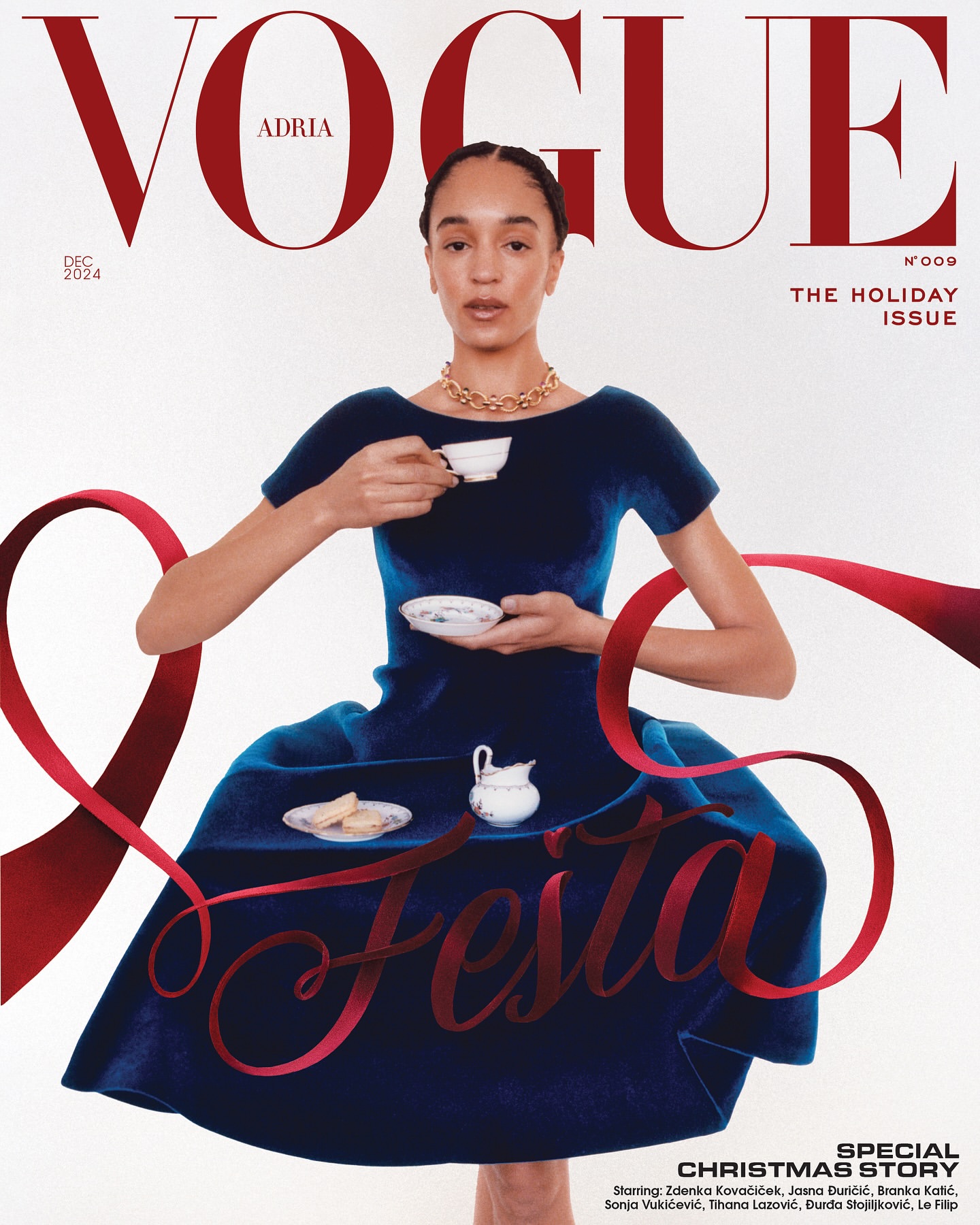 Vogue Adria cover featuring a woman in a blue dress holding a tea cup, with red ribbon accents and holiday-themed text overlays.