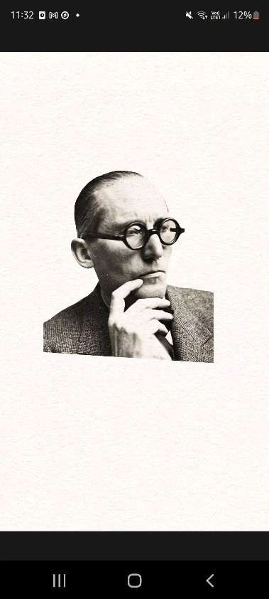Portrait of a man with glasses in grayscale, wearing a suit and tie, with his hand to his face in a thoughtful pose.