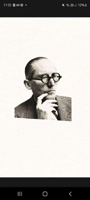 Portrait of a man with glasses in grayscale, wearing a suit and tie, with his hand to his face in a thoughtful pose.