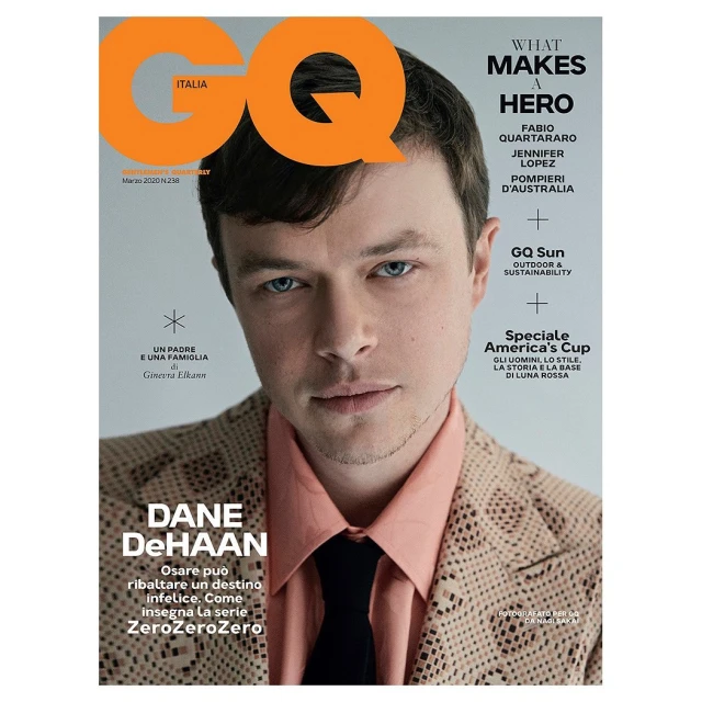GQ Italia cover featuring Dane DeHaan in a patterned suit, a light orange shirt, and a dark tie. Close-up studio shot with various text elements.