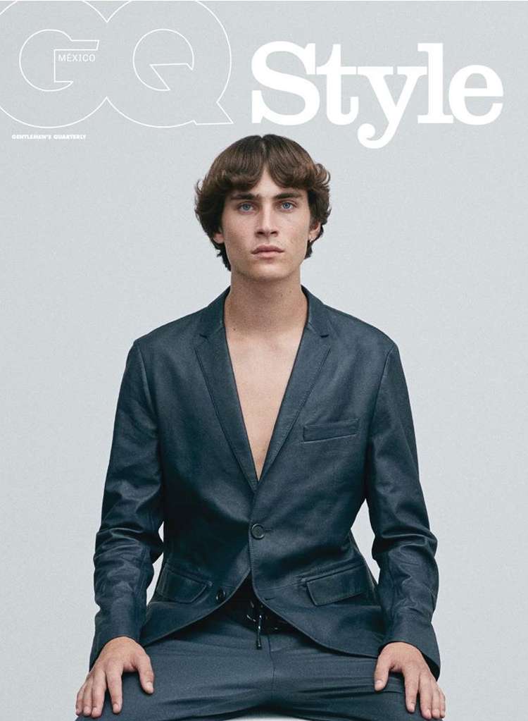 GQ Style cover featuring a fair-skinned adult male in a navy suit sitting against a pale grey studio background with visible GQ and Style logos.