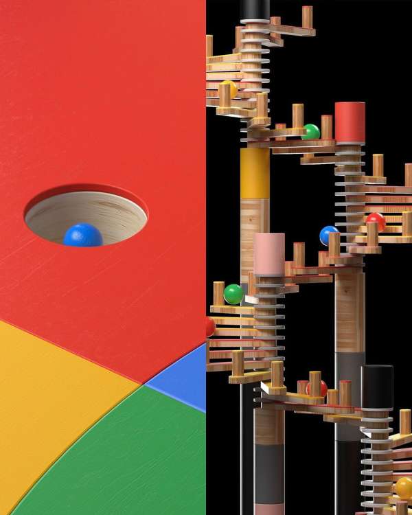 Colorful marble run animation with a blue ball dropping into a hole on a Google-colored surface, against a black backdrop.