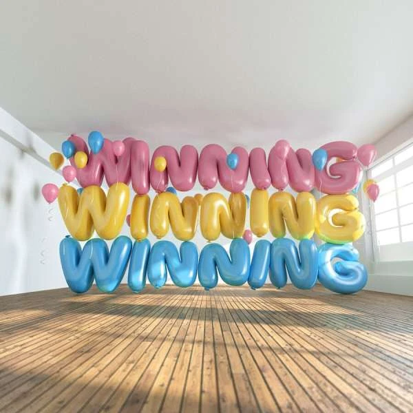 Three rows of balloon letters spelling 'Winning' in pink, yellow, and blue. Balloons also dot the bright white room with a wood floor.