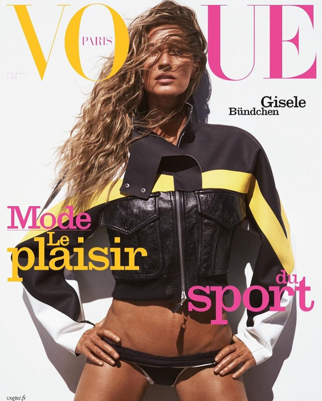 Vogue cover featuring Gisele Bundchen in a black and yellow jacket and bikini bottom against a white background with magazine text.