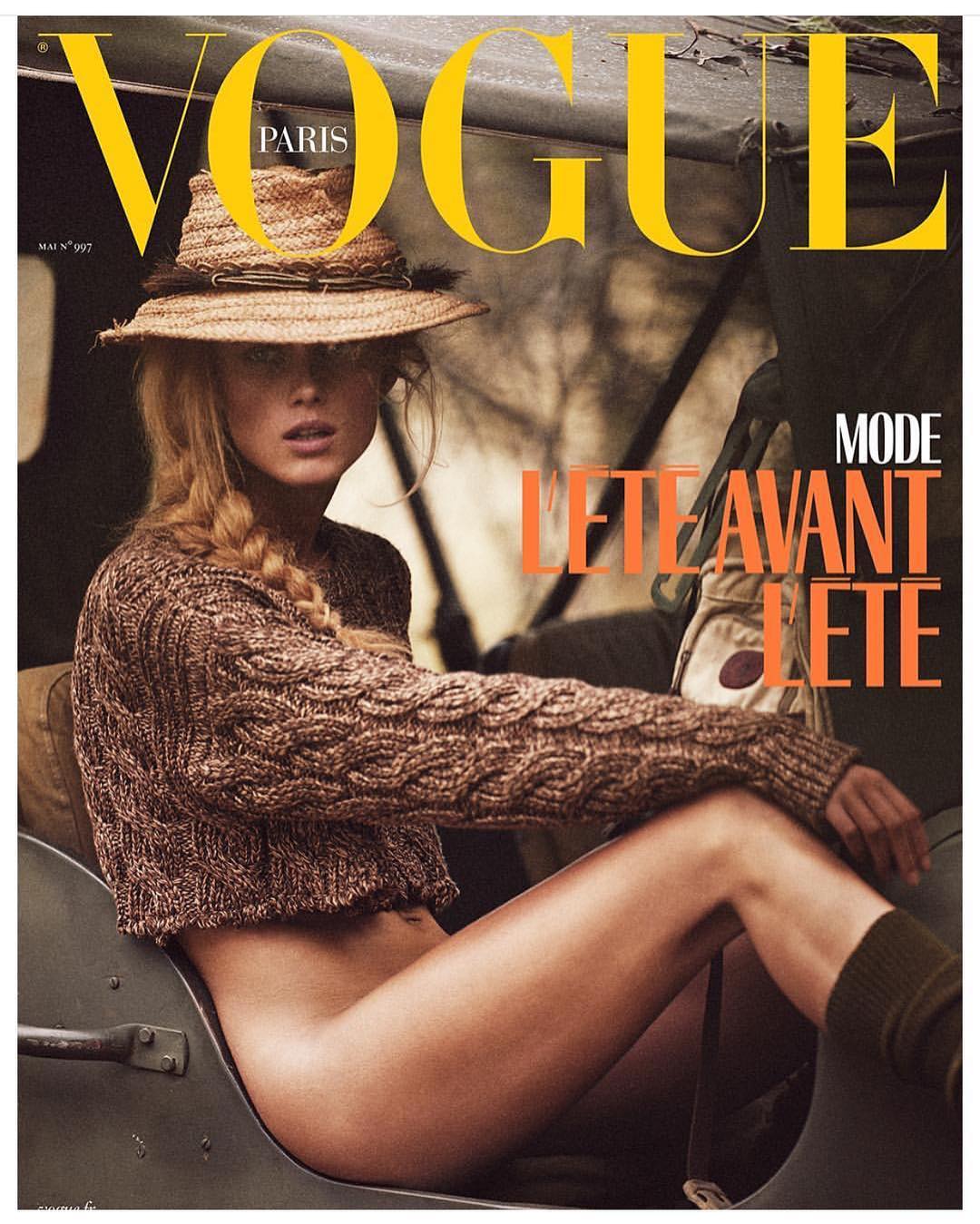 Model wearing a straw hat and brown cable knit sweater seated in an outdoor vehicle by Mikael Jansson