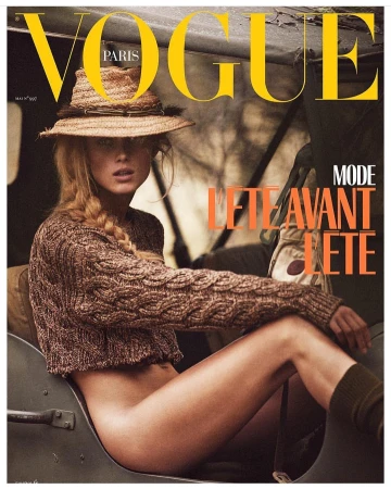 Model wearing a straw hat and brown cable knit sweater seated in an outdoor vehicle by Mikael Jansson