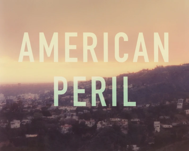 Hillside neighborhood under a gradient sky with overlaid text 'American Peril'.