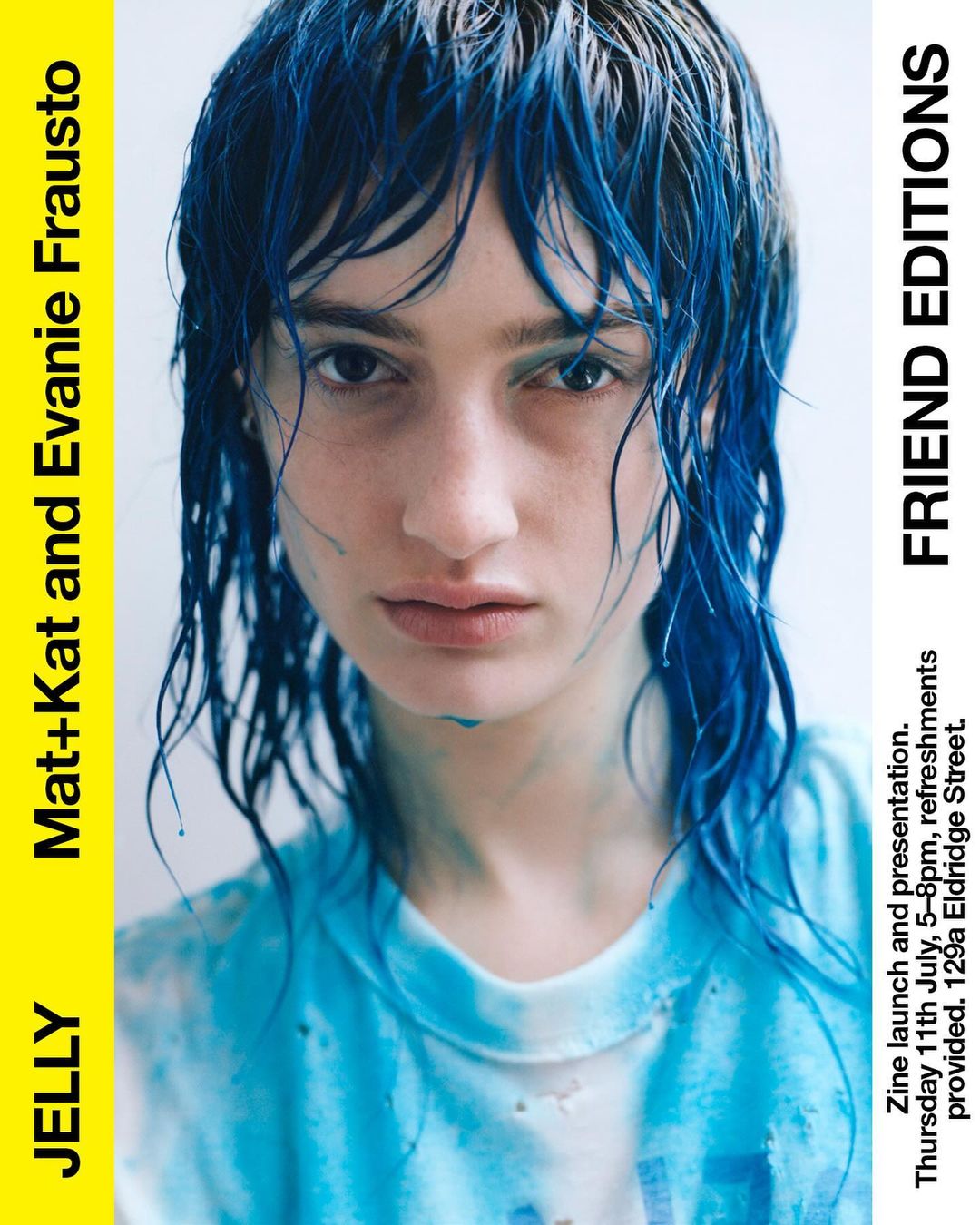 Close-up of a woman with blue-dyed hair, fair skin, and a slightly pensive expression, as part of a zine launch promotion.