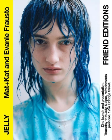 Close-up of a woman with blue-dyed hair, fair skin, and a slightly pensive expression, as part of a zine launch promotion.