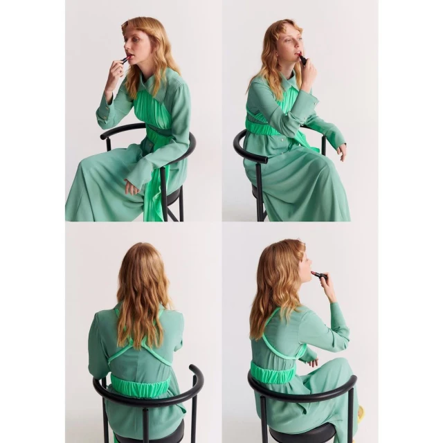 Four views of a blond adult woman in a green dress seated on a black chair, applying lipstick against a plain white background.