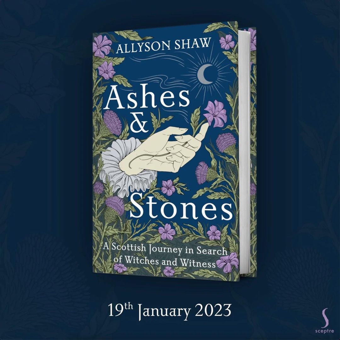 Book cover of "Ashes & Stones" by Allyson Shaw with a hand illustration, flowers, and moon on a navy background.