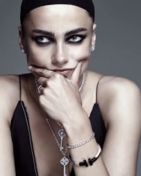 Close-up portrait of a woman in a black top with heavy eye makeup and layered diamond jewellery by photographer Hong Jang Huyn