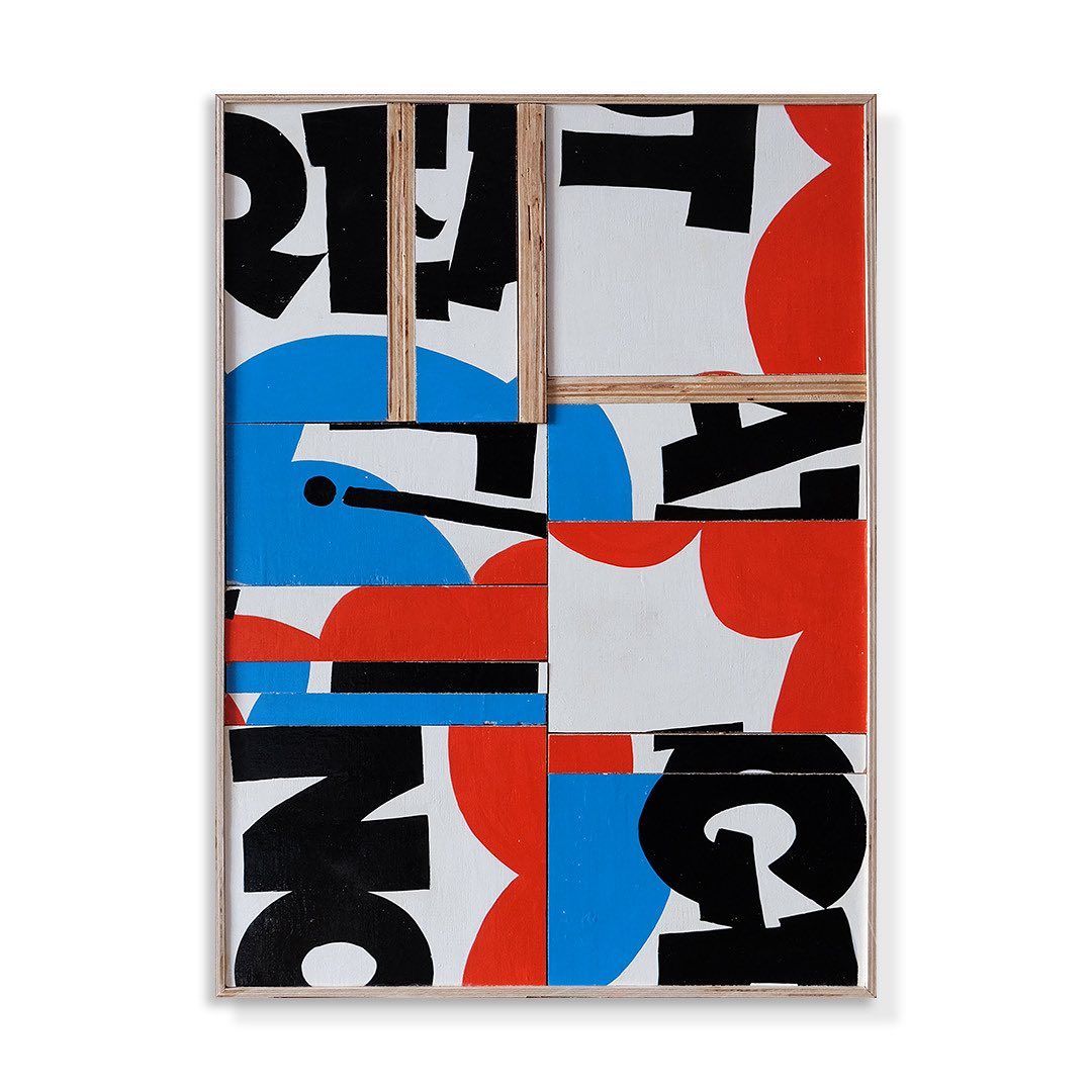 Abstract art featuring geometric shapes, blocks of color in red, blue, and black, and typography in a wood frame.