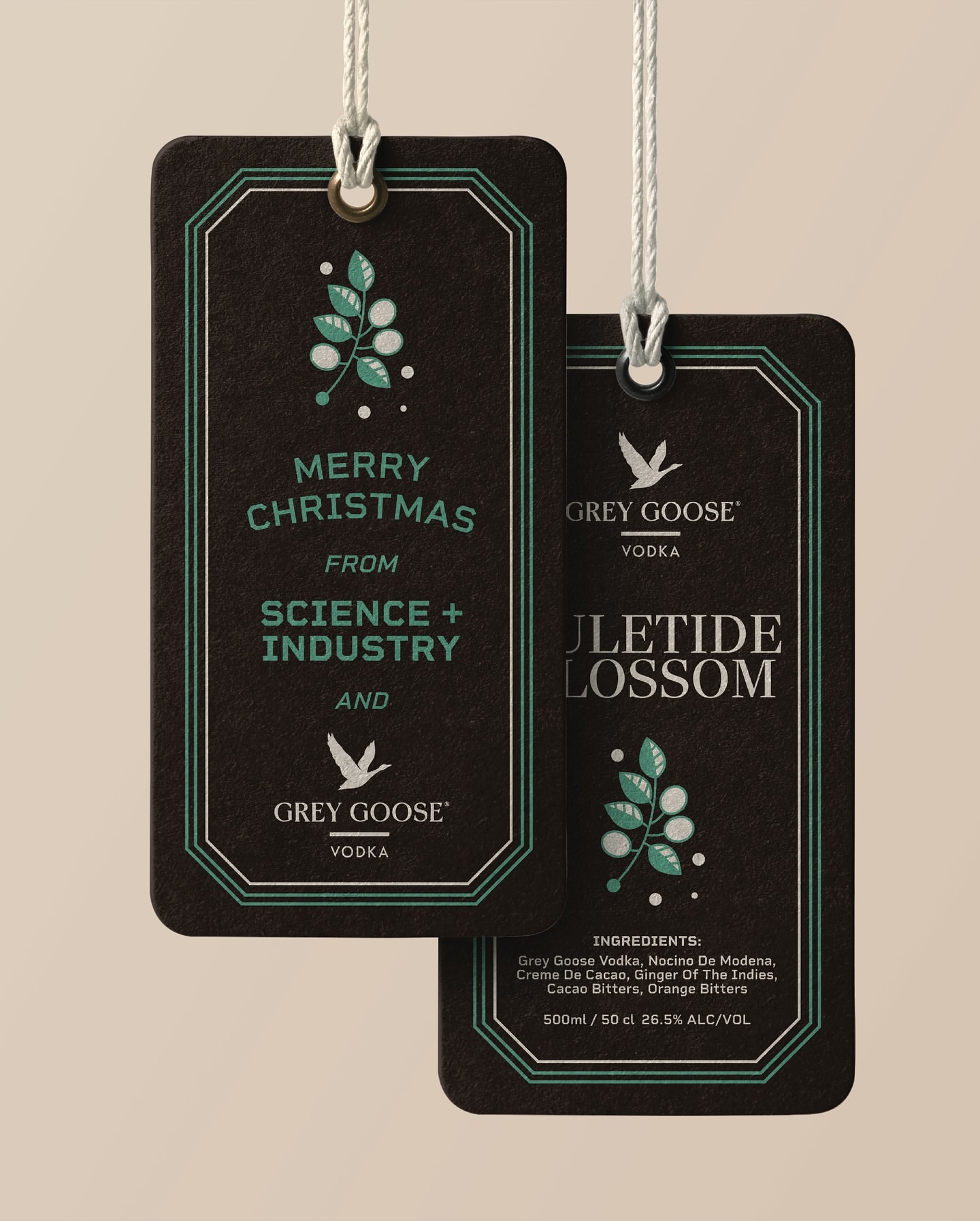 Grey Goose Vodka holiday gift tag featuring a festive holiday greeting and brand logo on a dark background with mint-green accents.