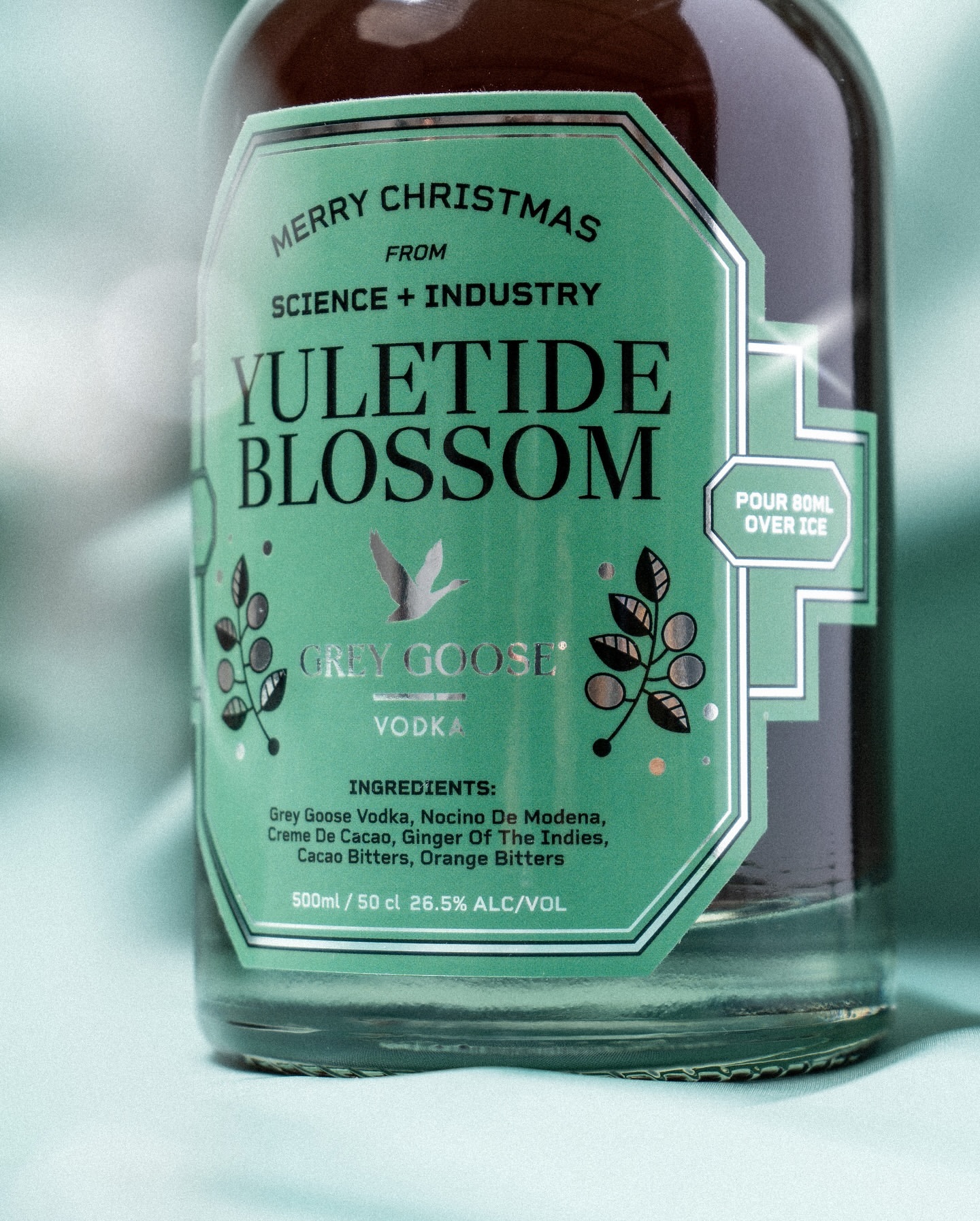 Grey Goose Vodka bottle with a green label that reads Merry Christmas, Yuletide Blossom, Science + Industry, 500ml, 26.5% alc/vol.