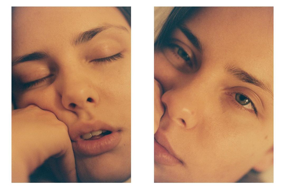 Close-up diptych of a fair-skinned young adult woman, one face with closed eyes, the other with green eyes open, warm, soft lighting.