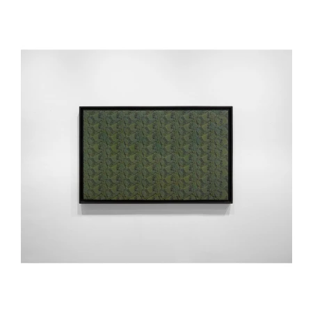 Framed abstract art featuring a textured, dark-green pattern, hanging on a white wall in an indoor setting with natural lighting.
