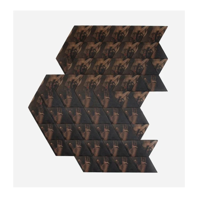 Abstract tile art pattern featuring multiple human faces and hands arranged in a geometric design on a white backdrop.