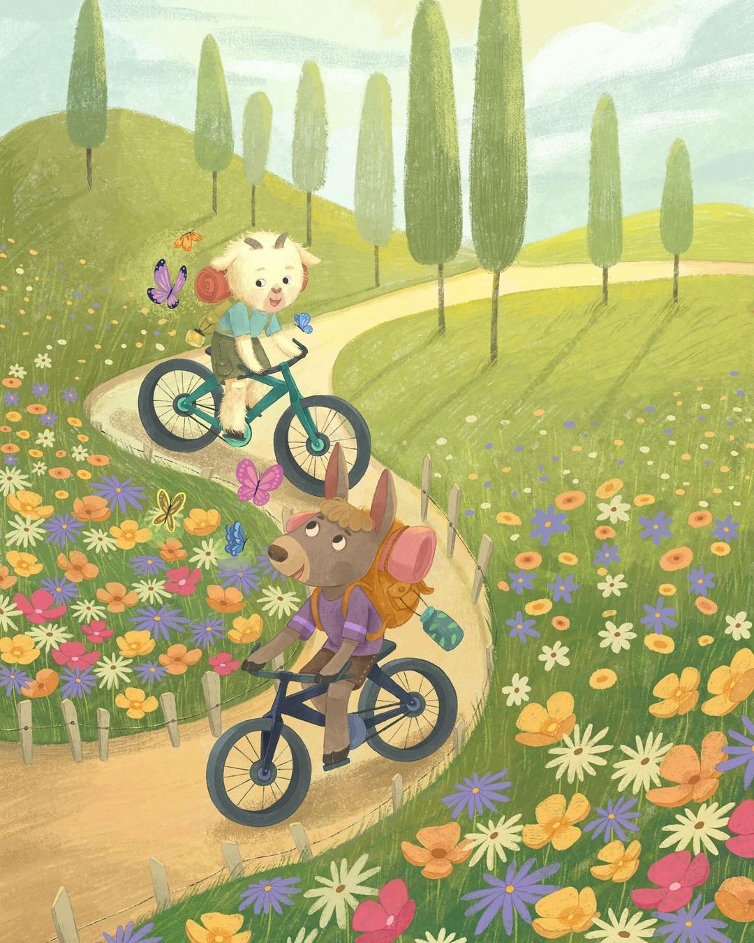 Illustration of a goat and donkey riding bicycles on a winding path surrounded by flowers in a green, hilly landscape. Butterflies visible.