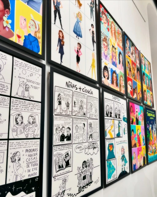 Wall display of framed art featuring cartoon and illustrated drawings in a brightly lit indoor setting.
