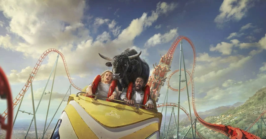 Two people riding a roller coaster with a bull superimposed in front of them, against a backdrop of a blue sky and mountains.