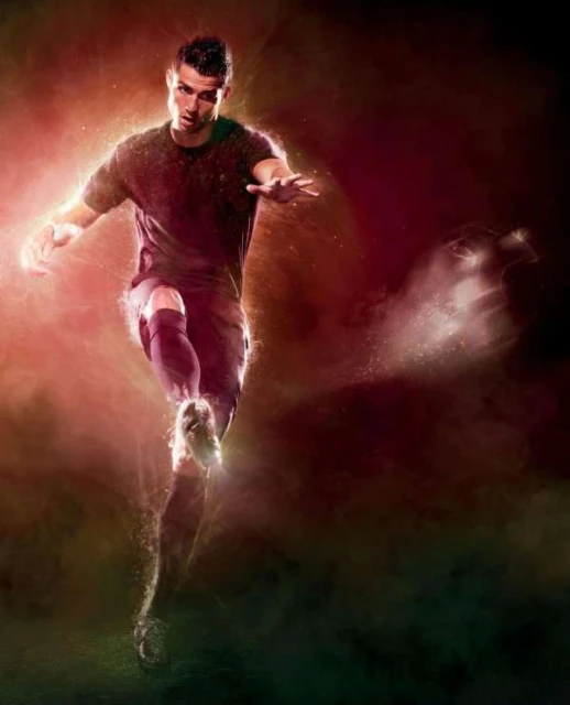 An adult male soccer player in action, wearing a jersey and shorts, kicks a soccer ball with energetic, red-toned, artistic visual effects.