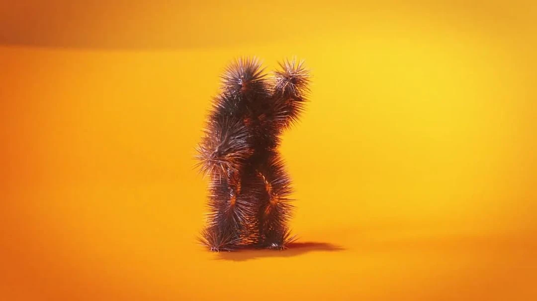 Spiky anthropomorphic figure stands in an orange-lit studio. Unique character with a textured, furry surface creating a surreal and intriguing image.